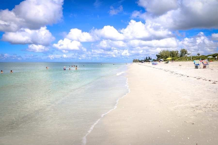 beachgoers and swimmers at blind pass beach in fl