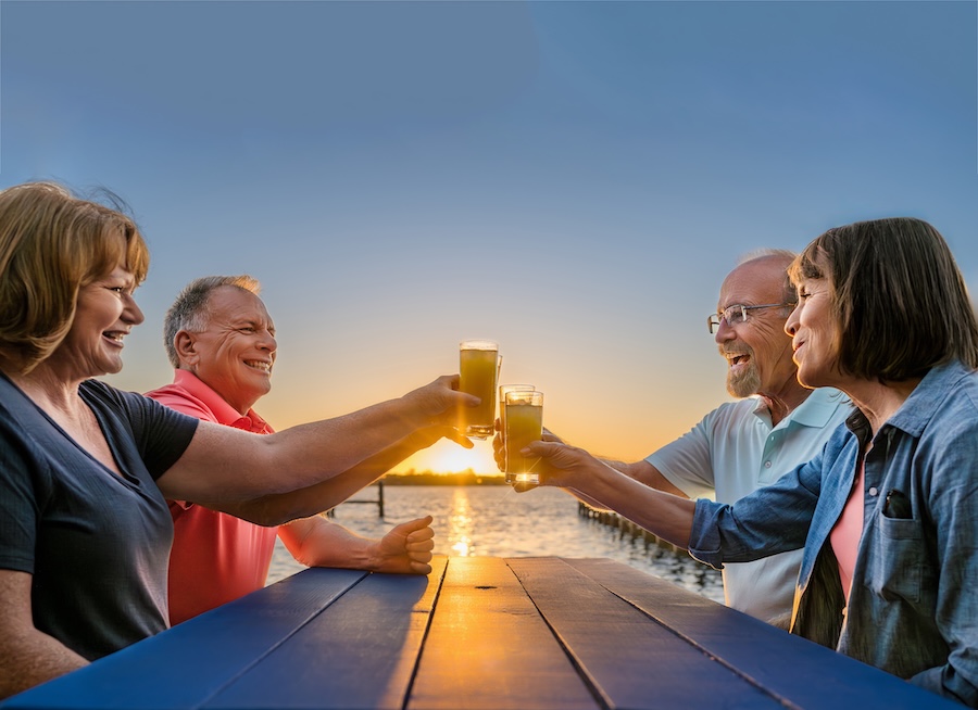 two couples toasting beer by the water in osprey fl