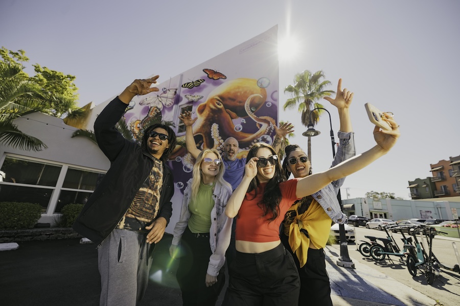 group of friends taking a selfie at burns court mural