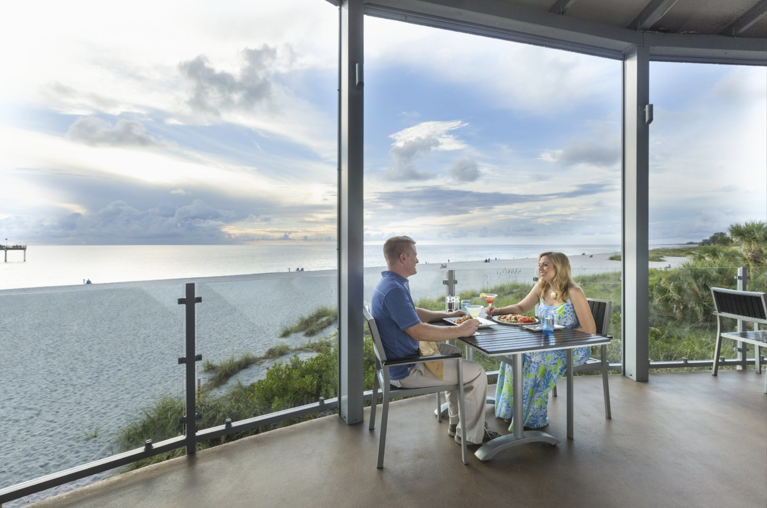 couple dining by the windows of waterfront venice fl restaurant